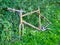 The rusty frame of a dumped cycle recovered from the Leeds to Liverpool Canal and left next to the towpath