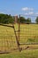 Rusty gate blocks off entrance to a field hay