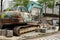 The rusty green excavator work at road construction site