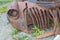 Rusty grille of an abandoned antique truck on the ground