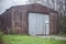 Rusty hangar with a gate.