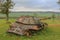 A rusty heavy Soviet IS-3 tank without tracks is rusting in the field