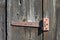Rusty hinge on old wooden door