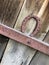 Rusty horseshoe on a wooden door for good luck