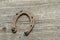 Rusty horseshoes on a wooden background - rustic scene in a country style.