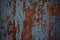 Rusty iron door with cracked blue paint. Painted blue rusty wall shaped texture. Grunge rusty corrosive background painted blue. S