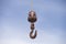 Rusty Iron hook against blue sky background