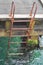 Rusty iron ladder on pier