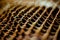 Rusty iron net weaving from wire. Surface with depth of field. Closeup mesh background