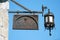 Rusty iron Pharmacy signboard with antique lantern at miracle square in Pisa,Italy
