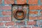 A rusty iron ring in an old brick wall