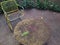 Rusty iron table and chairs and wooden floor on the terrace.