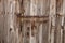 Rusty latch on an old wooden door