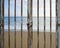 Rusty locked door with beach ocean and sky