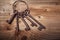 Rusty medieval keys on wood table