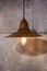 Rusty metal chandelier in the loft style, Edison bulb, the original beautiful pendant lamp on a gray concrete background