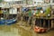 Rusty metal constructions of fishermen with riverboats of fishing village