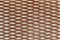 Rusty metal mesh made of thick brown iron with identical cells in the shape of a pointed ellipse