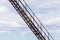 Rusty metal stairway goes up under cloudy sky