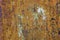 Rusty metal texture background. Old worn iron door with peeled off orange paint