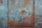 Rusty metal wall background with weathered texture and paint remnants