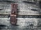 Rusty metal on wooden plank