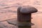 Rusty mooring bollard closeup