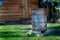 Rusty old charred steel firepit barrel in garden.