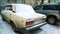 Rusty old dirty white car VAZ 2105 or Lada Classic brand Riva or Nova in Europe covered snow. Popular legendary Russian auto