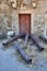 Rusty old disused cannons by a wooden door