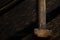Rusty old hammer on wet black wood background