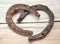 Rusty old iron horseshoes as a love heart sign