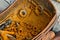 Rusty old nuts and bolts in a rustic wooden box on a workbench, industrial close up concept