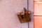 A rusty old padlock is locked on metal doors. No entry, security