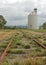 Rusty old railway tracks and wheat silo