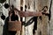 Rusty old steel padlock hanging on the wooden door. Retro tones processing
