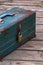 Rusty old toolbox locked up sitting on a wood