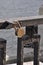 Rusty padlock on a cobweb parapet