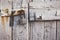 Rusty padlock hanging on an ancient white wooden gate - great for a background or wallpaper