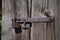 Rusty padlock on old weathered door