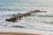 Rusty pier on the background of the sea and waves