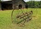 Rusty Plow by Barn