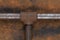 Rusty plumb tube on rusty metal wall