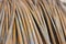 rusty rebar rods lie in a pile near the construction site of the viaduct