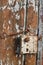 Rusty rural  handmade  lock  on aged wooden  shed door