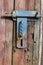 Rusty rural  handmade  lock  on aged wooden  shed door