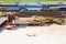 Rusty sheets of metal and a red hook for a construction crane lie on a pallet in a warehouse of an open industrial site at an