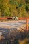 Rusty sign in front of the barrier with the inscription: caution, radiation, concrete road, exclusion zone, contaminated area.