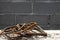 Rusty steel rebar scraps. Stack of rust.y iron rods or bars on the background of a concrete wall