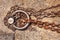 Rusty steel ring and mooring lines in a seaport. Rusty iron chain on the ground